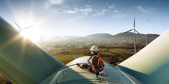 working overlooking wind turbine field