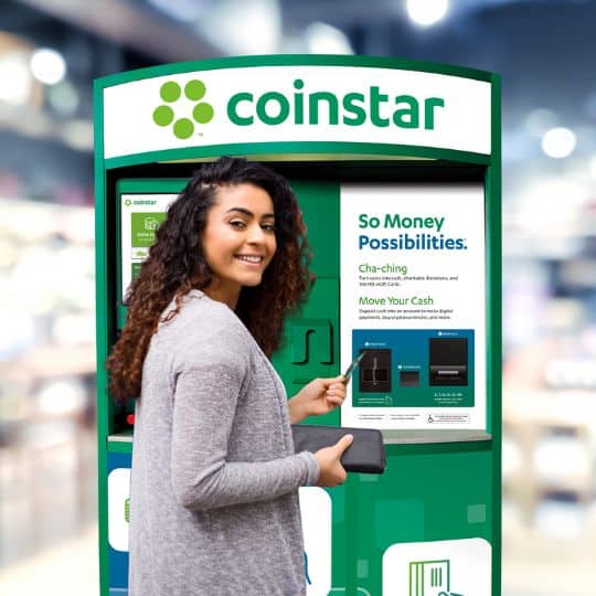 women in front of cointstar machine