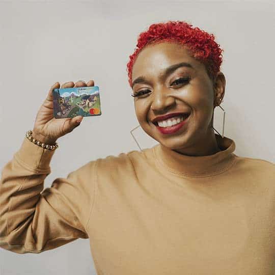 women holding clean energy credit union debit card