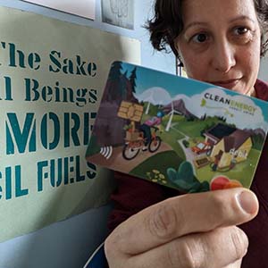 Photo of Joelle holding up her Clean Energy Credit Union Debit Card