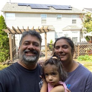 family in front of home with solar