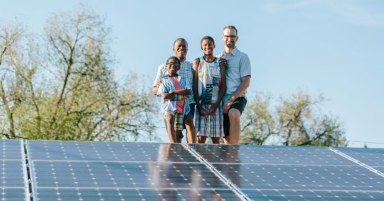 family on roof with solar