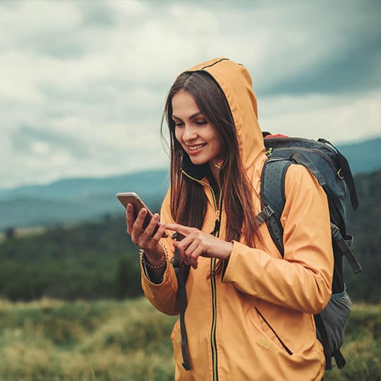 Woman using mobile phone in nature