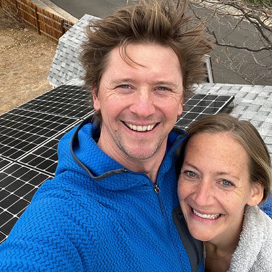 happy couple celebrating new solar roof